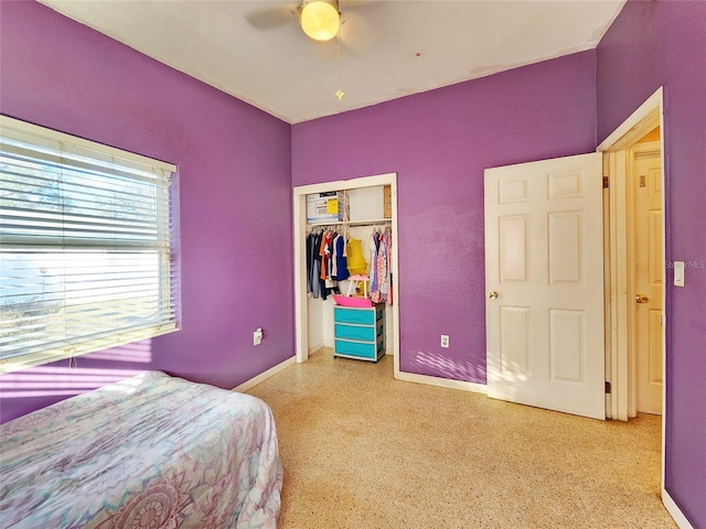 bedroom with speckled floor, baseboards, a ceiling fan, and a closet