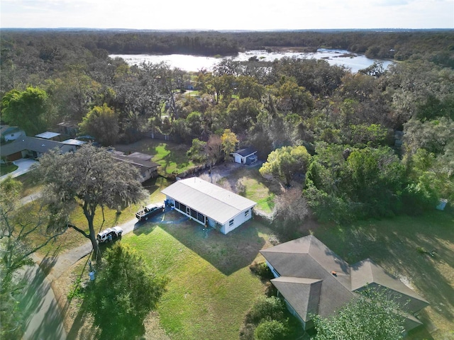aerial view with a forest view and a water view