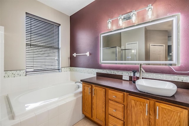 bathroom with vanity and separate shower and tub