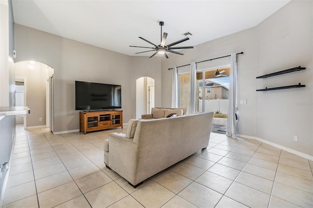 living room featuring light tile patterned floors and ceiling fan