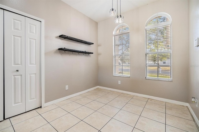 unfurnished room with plenty of natural light and light tile patterned floors