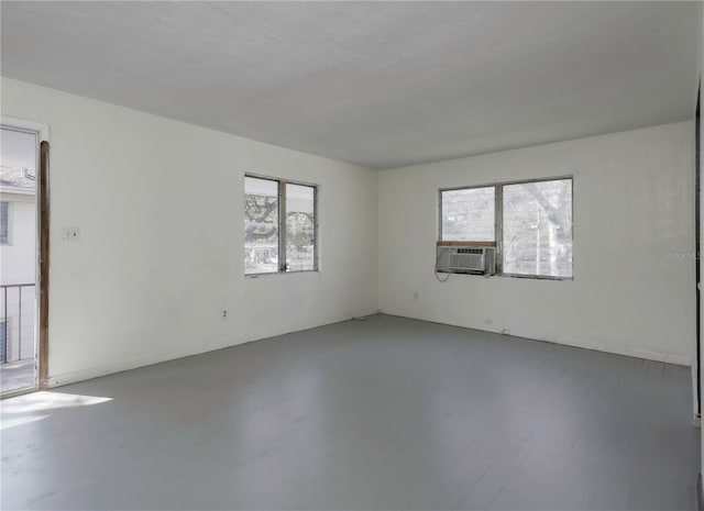 unfurnished room with cooling unit and concrete floors