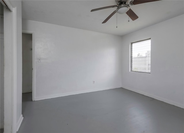 spare room featuring concrete floors and ceiling fan