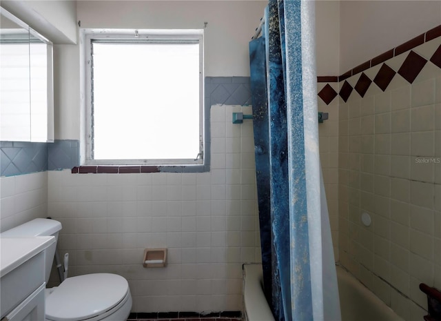 full bathroom with shower / bath combination with curtain, vanity, toilet, and tile walls