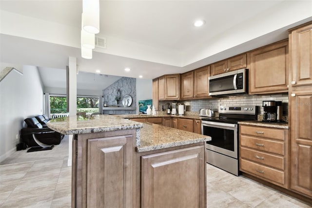 kitchen featuring lofted ceiling, tasteful backsplash, kitchen peninsula, stainless steel appliances, and light stone countertops