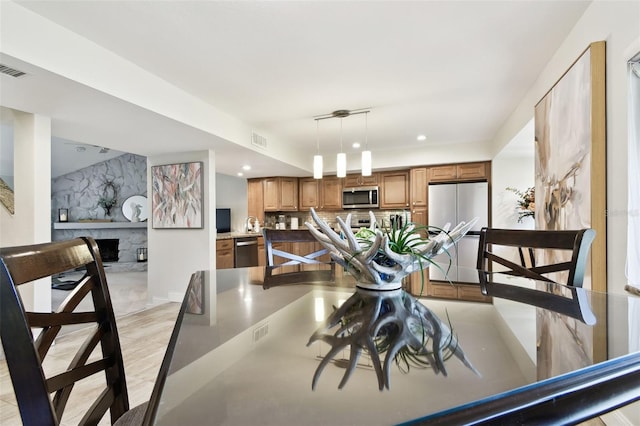 dining space featuring a fireplace