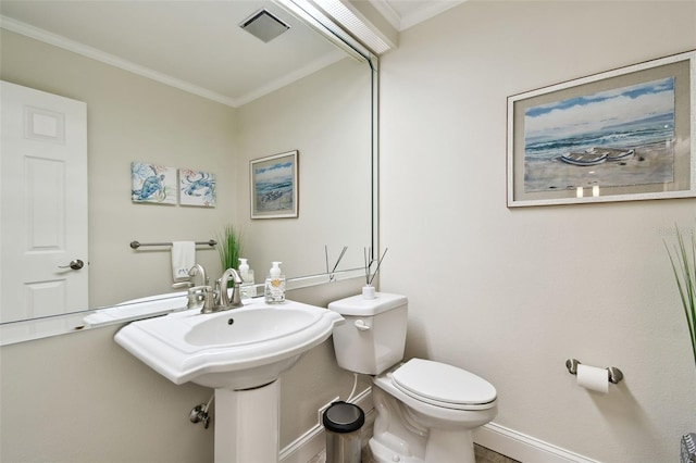 bathroom featuring ornamental molding and toilet