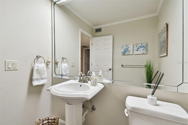 bathroom featuring ornamental molding and toilet