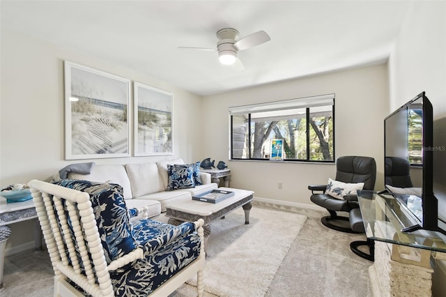 carpeted living room featuring ceiling fan