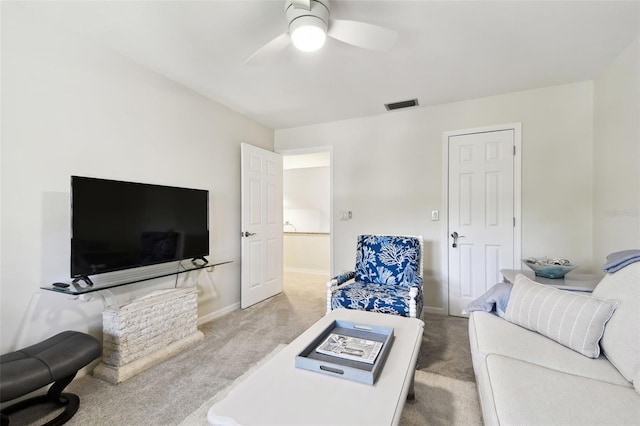 carpeted living room with ceiling fan