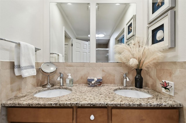 bathroom featuring tasteful backsplash, ornamental molding, a shower with shower door, and vanity