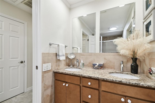 bathroom featuring ornamental molding, vanity, and tile walls