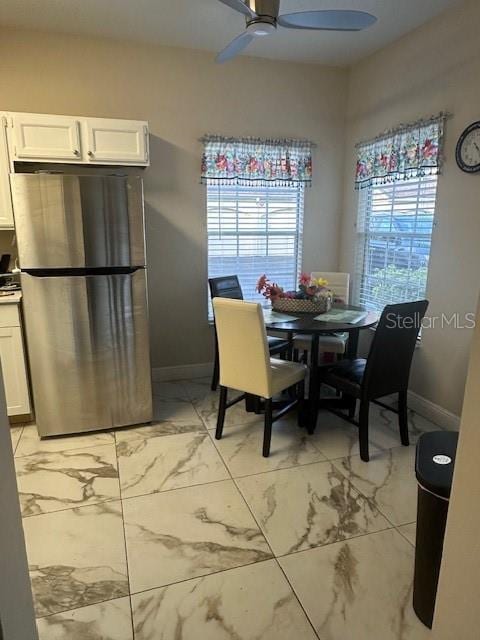 dining space featuring ceiling fan and a healthy amount of sunlight