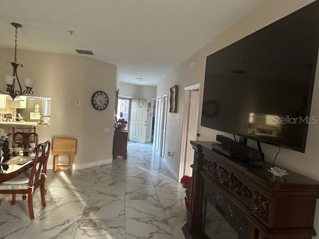 hallway featuring an inviting chandelier