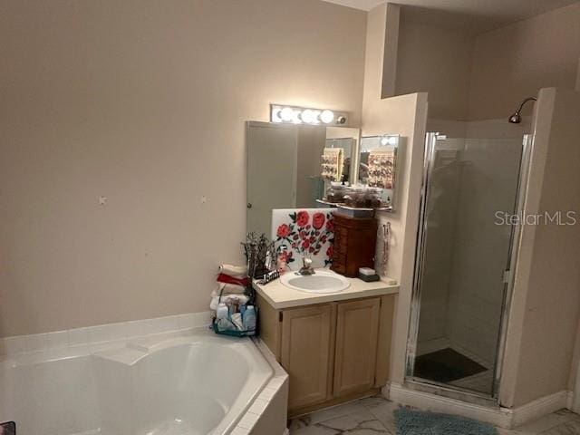 bathroom with vanity and independent shower and bath