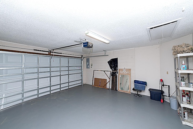 garage with a garage door opener and electric panel