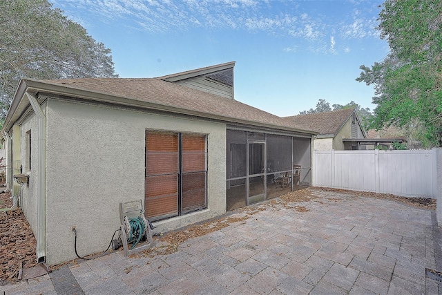 back of house with a sunroom and a patio area