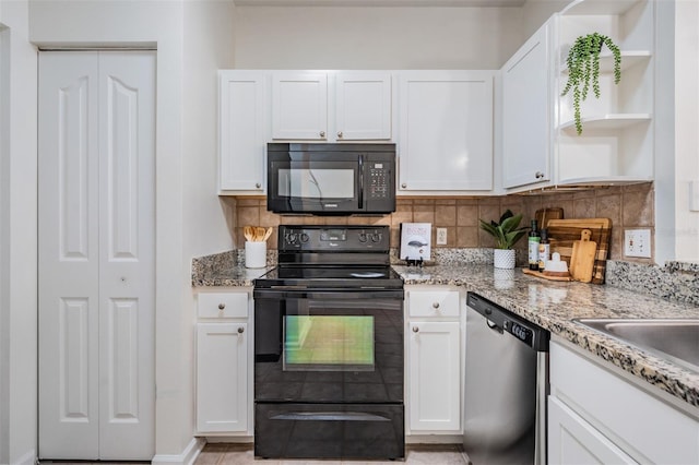 kitchen with white cabinetry, light stone countertops, decorative backsplash, and black appliances