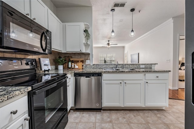 kitchen featuring stone counters, pendant lighting, sink, white cabinets, and black appliances