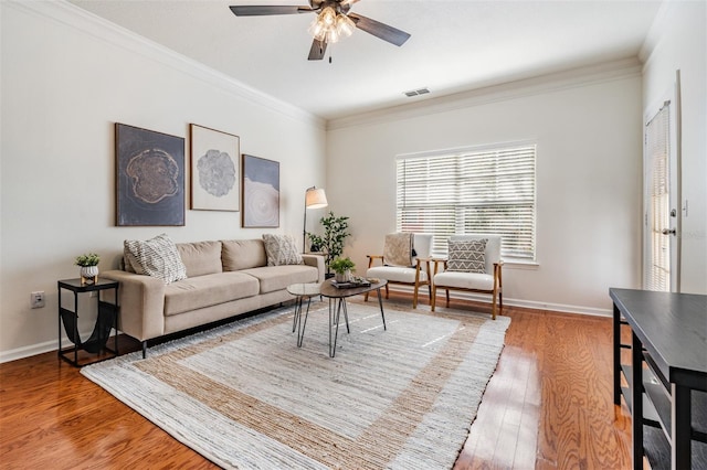 living room with crown molding, ceiling fan, and hardwood / wood-style floors