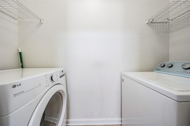 clothes washing area featuring independent washer and dryer