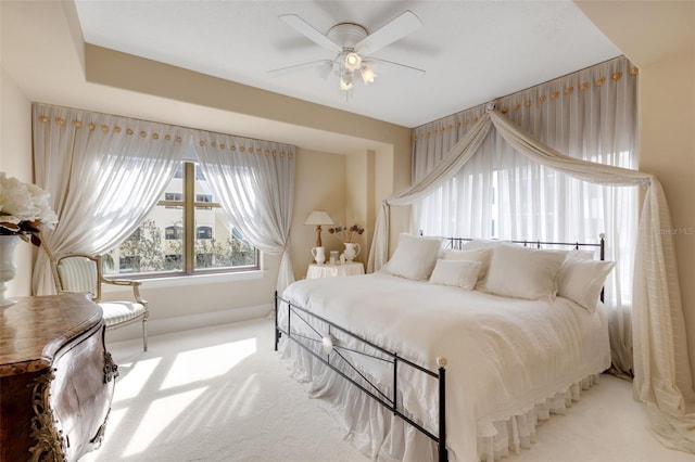 bedroom featuring light colored carpet and ceiling fan