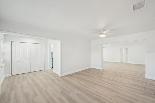 empty room featuring ceiling fan and light wood-type flooring