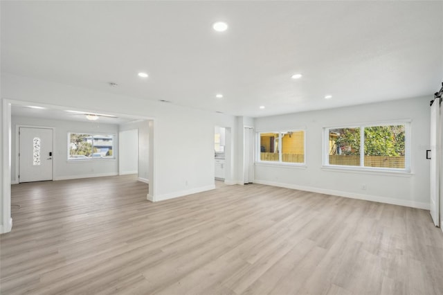 unfurnished living room with light wood-type flooring