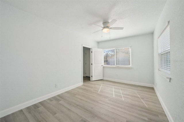 empty room with ceiling fan and light wood-type flooring