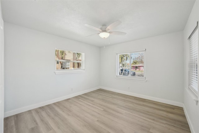 unfurnished room with a textured ceiling, light hardwood / wood-style floors, and ceiling fan