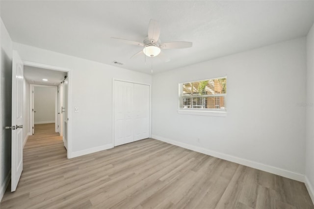 unfurnished bedroom featuring light hardwood / wood-style flooring, ceiling fan, and a closet