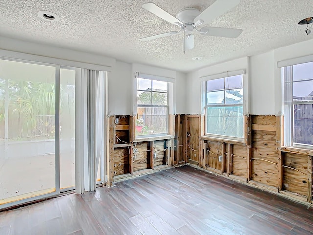 unfurnished sunroom featuring ceiling fan