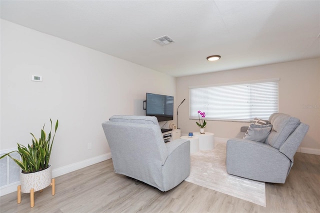 living room with light hardwood / wood-style flooring