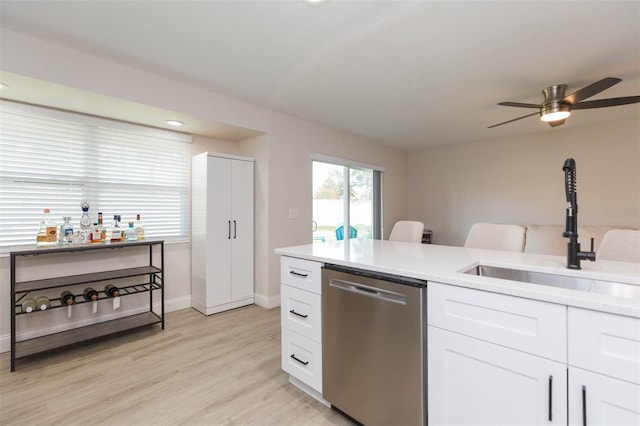 kitchen featuring white cabinetry, dishwasher, sink, and light wood-type flooring