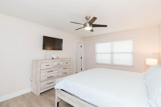 bedroom with ceiling fan and light hardwood / wood-style floors