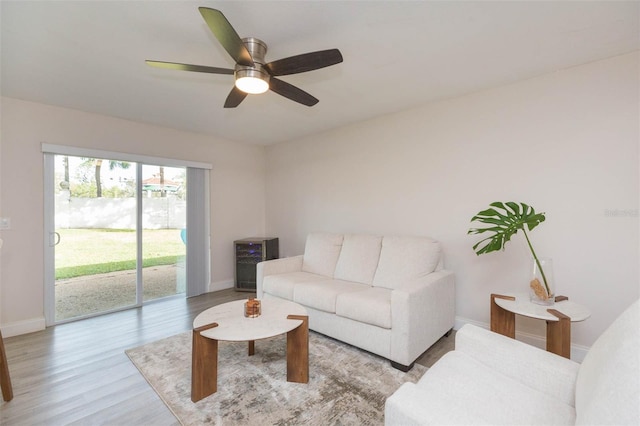 living room featuring ceiling fan and light wood-type flooring