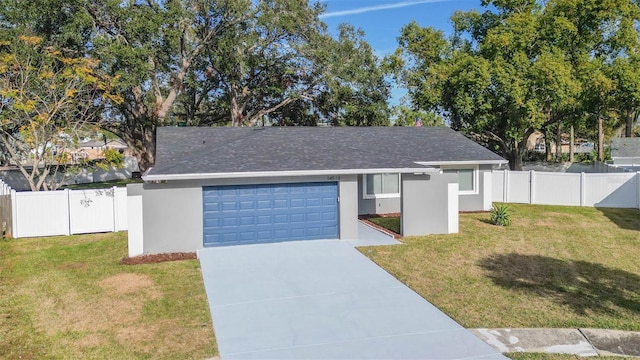 view of front of property featuring a garage and a front lawn