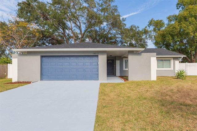 view of front of property featuring a garage and a front yard