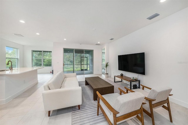 living room with sink and light tile patterned floors