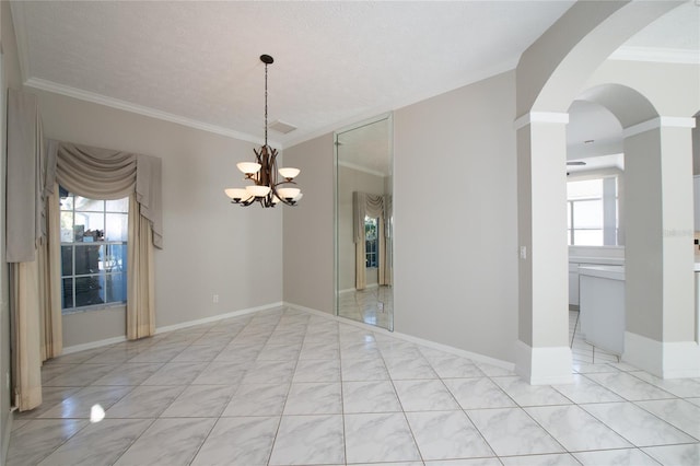 tiled empty room with a notable chandelier, crown molding, and plenty of natural light