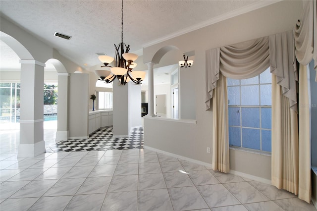 unfurnished dining area with crown molding, a textured ceiling, and an inviting chandelier