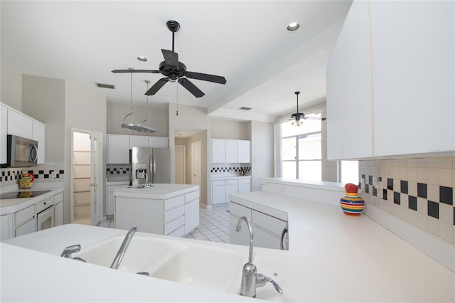 bathroom featuring vanity, ceiling fan, and decorative backsplash