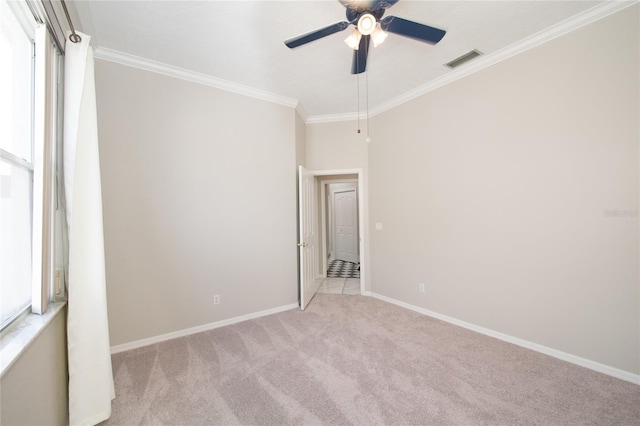 unfurnished room with crown molding, light carpet, and ceiling fan