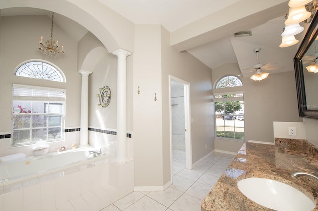 bathroom with tile patterned floors, ornate columns, vaulted ceiling, tiled tub, and ceiling fan