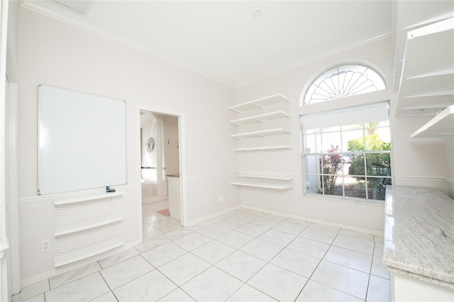 unfurnished room featuring light tile patterned flooring and ornamental molding