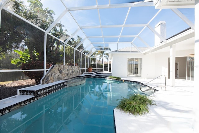 view of pool with a lanai and a patio