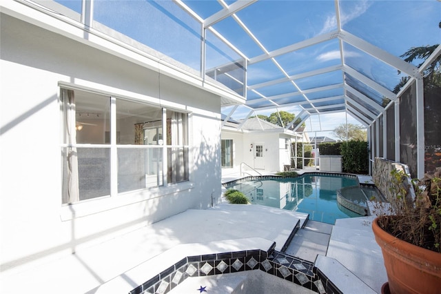 view of swimming pool featuring a patio and glass enclosure