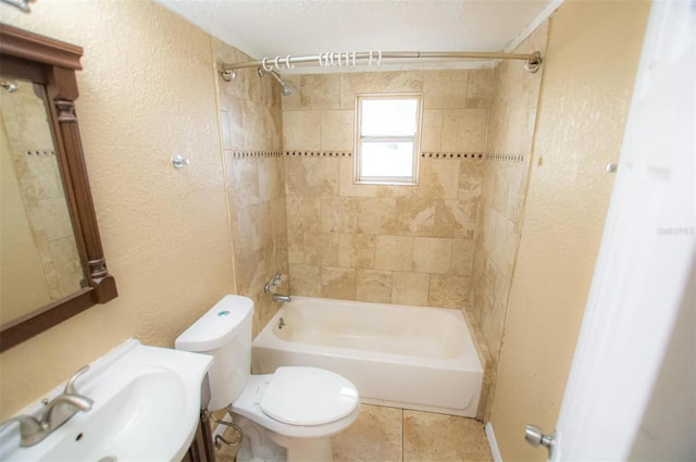 full bathroom featuring tiled shower / bath, vanity, toilet, and tile patterned flooring