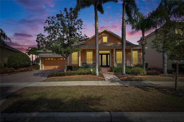 view of front of property with a porch and a garage