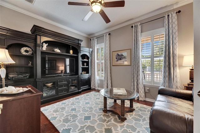 living area with dark hardwood / wood-style flooring, crown molding, plenty of natural light, and ceiling fan